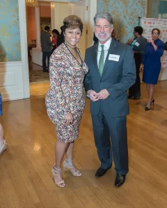 Woman in dress with C STEM donor at event.