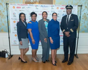 Five people at a C STEM donor event pose in front of a banner with sponsor logos.